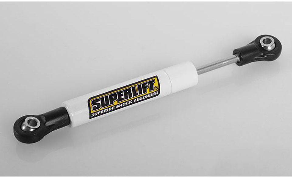 Stoßdämpfer mit der Aufschrift 'Superlift Superide Shock Absorber'. Weiße Röhre mit schwarzen Enden, für Geländewagen geeignet.