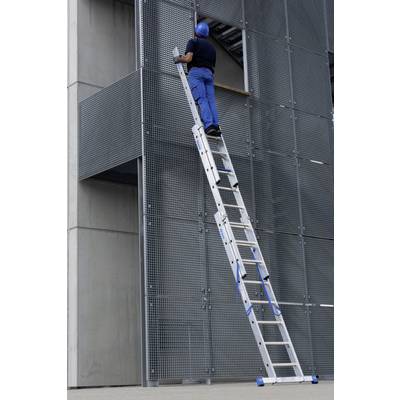 Ein Arbeiter in blauer Kleidung und Helm steht auf einer langen Leiter, die an einer Gebäude-Fassade angelehnt ist.