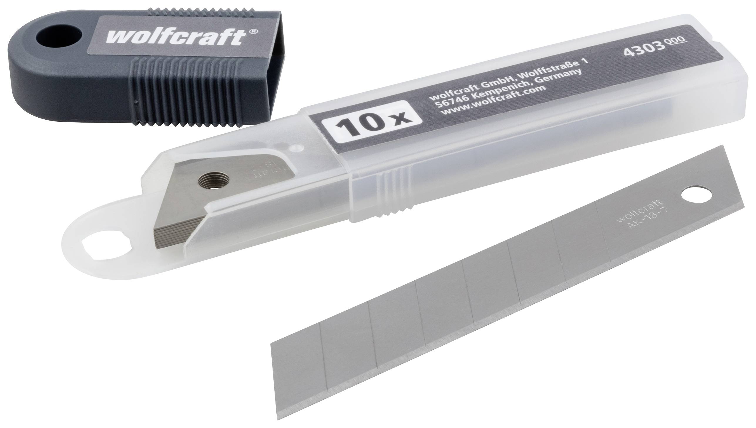 Plastikbox mit 10 Ersatzklingen für Teppichmesser, Hersteller 'wolfcraft', daneben geöffneter Verschluss und eine herausgenommene Klinge.