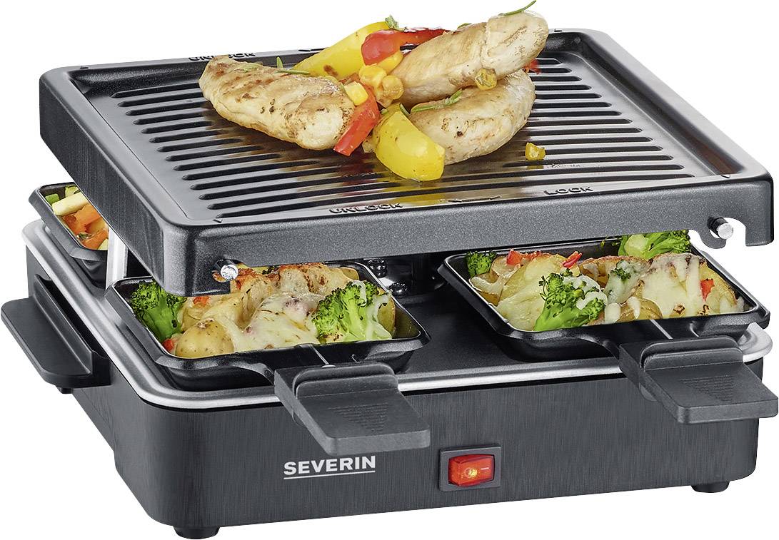 Ein elektrischer Grill mit zwei Grillflächen. Auf der oberen Fläche liegen gegrillte Würstchen und Gemüse. Vier Pfännchen mit Gemüse befinden sich darunter.