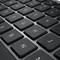 Nahaufnahme einer schwarzen QWERTZ-Tastatur, die mehrere Tasten zeigt, darunter Buchstaben- und Zahlentasten.