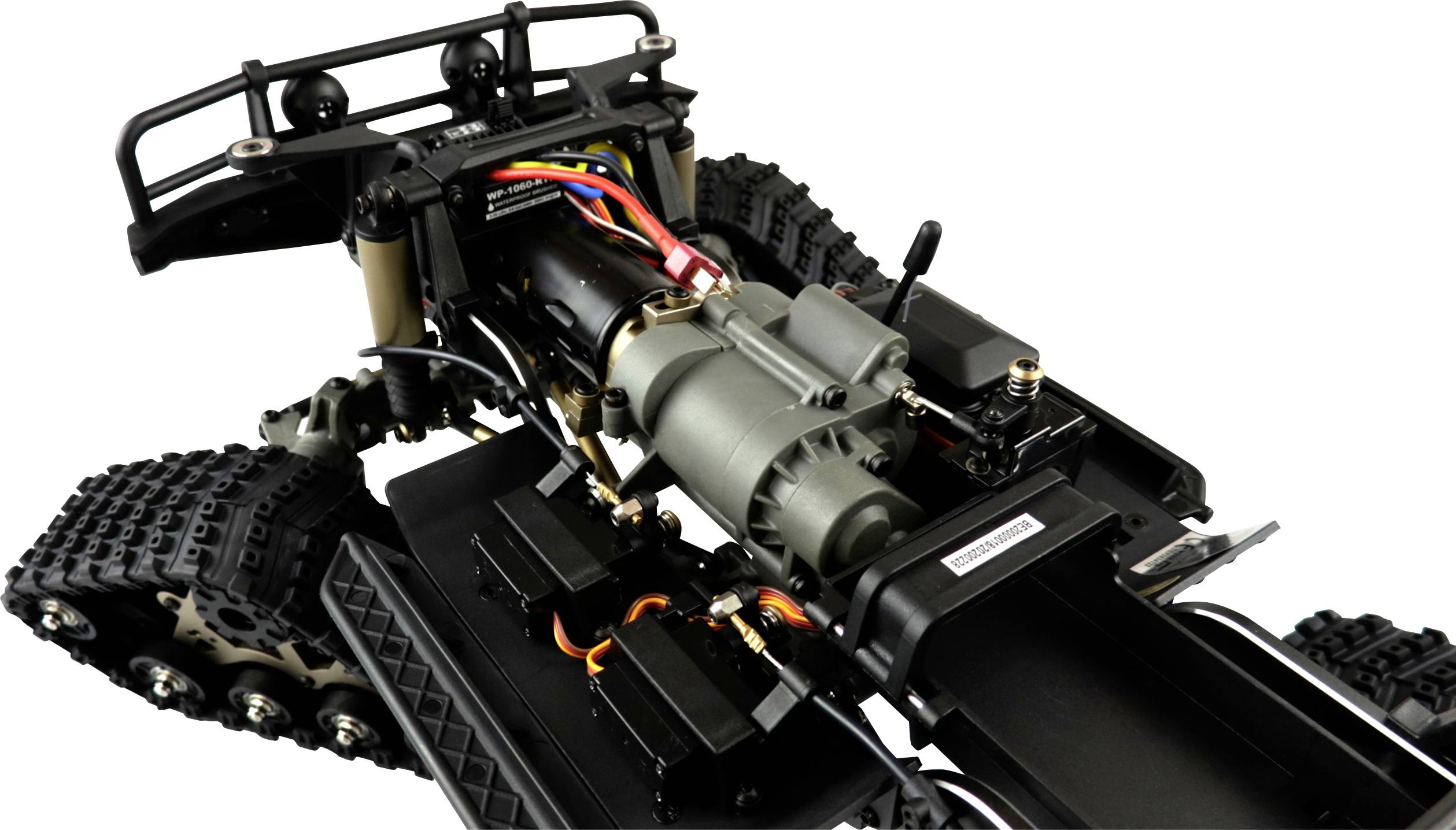 Nahaufnahme eines ferngesteuerten Kettenfahrzeugchassis mit sichtbarem Elektromotor, Verkabelung und Federungsteilen.
