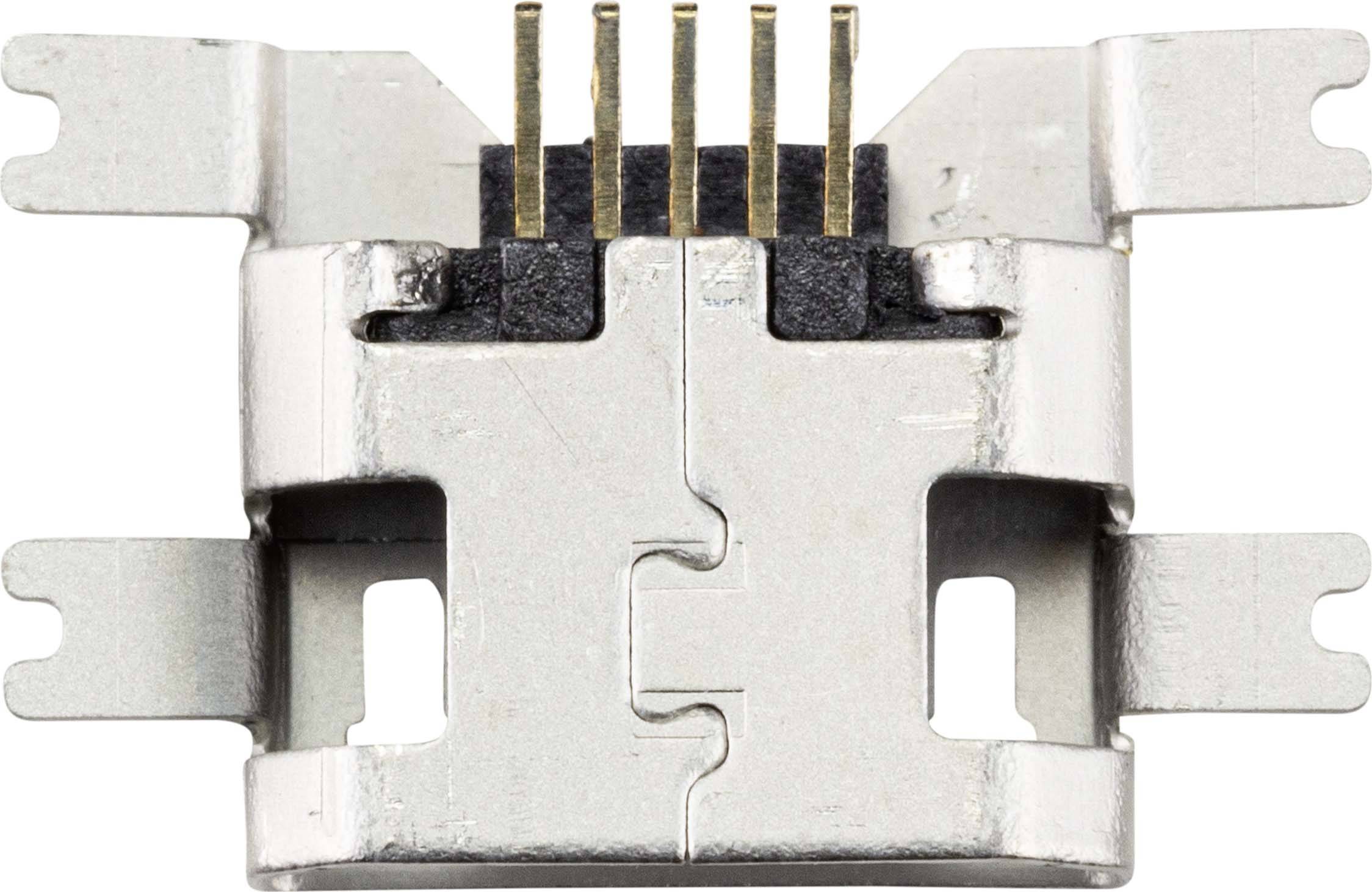 Metallclip mit fünf Steckkontakten, die aus einem schwarzen Kunststoffgehäuse herausragen. Clip hat seitliche Befestigungslaschen.