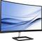 Ein geschwungener Philips-Monitor mit einem eleganten, modernen Design, auf dem ein blauer, abstrakter Hintergrund angezeigt wird.