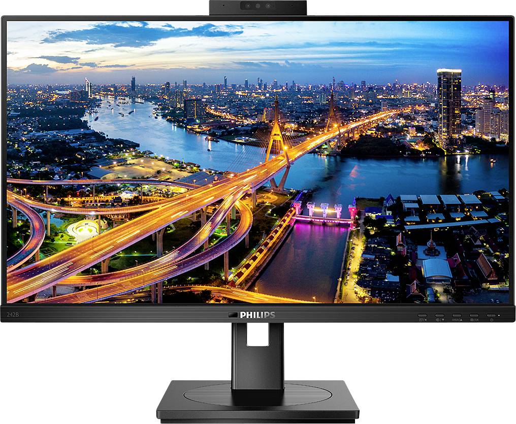 Ein Monitor zeigt ein lebendiges Stadtpanorama bei Nacht mit erleuchteten Brücken und Flüssen; stark besiedelte Skyline im Hintergrund.
