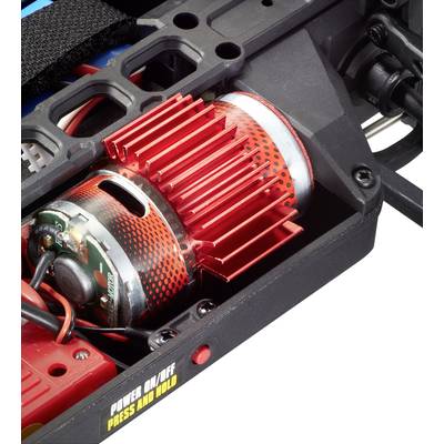Ein elektrischer Motor mit rotem Kühlkörper in einem technischen Gerät. Ein Schalter mit Aufschrift 'POWER ON/OFF PRESS AND HOLD'.