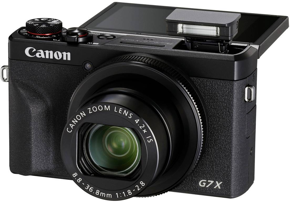 'Digitalkamera mit Zoom-Objektiv und ausklappbarem Bildschirm, Modell Canon G7X, angezeigt in seitlicher Ansicht.'