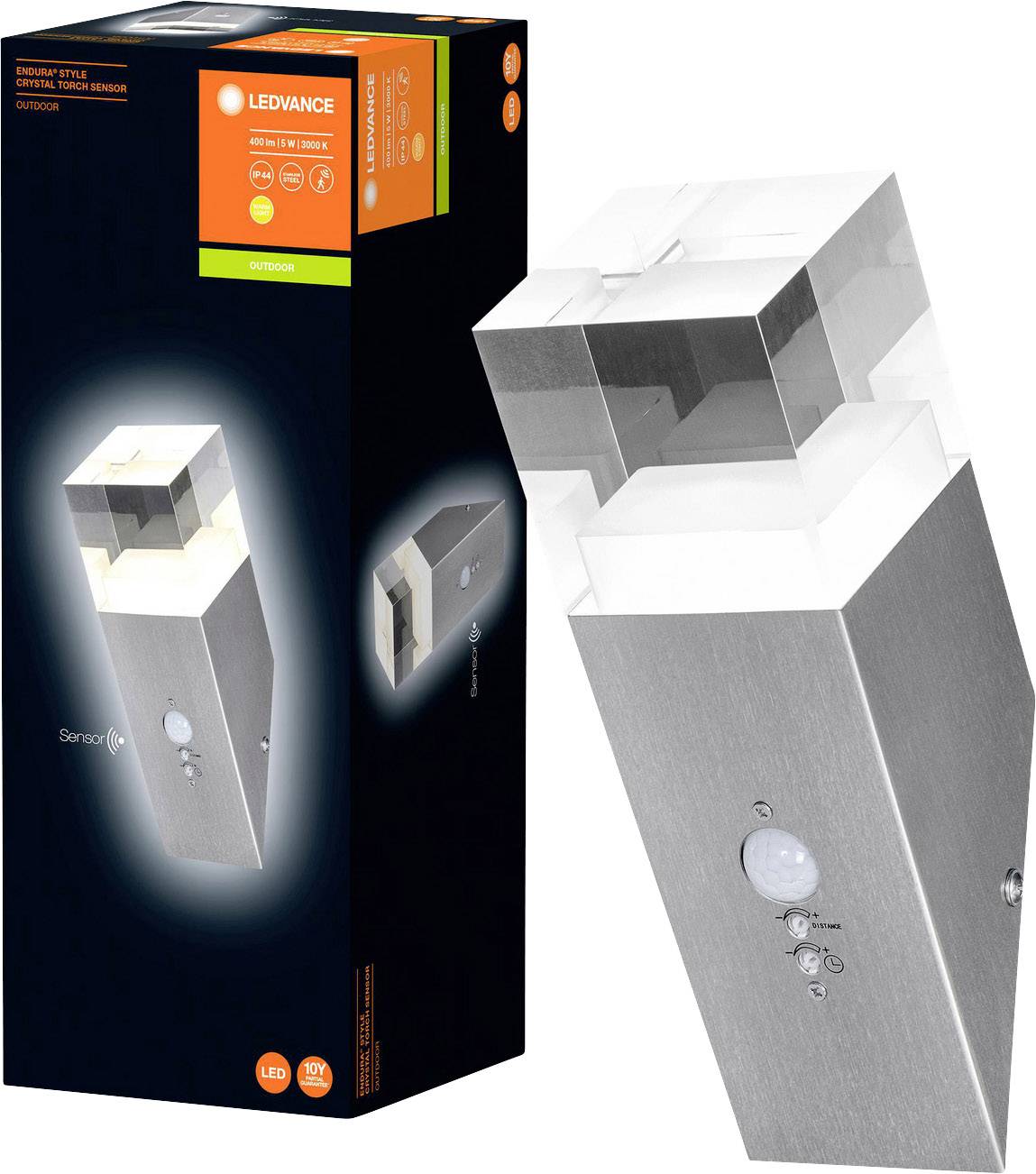 Außenwandleuchte mit Bewegungssensor, quadratisches Design aus gebürstetem Metall und Glas, Verpackung links zeigt Produktdetails.
