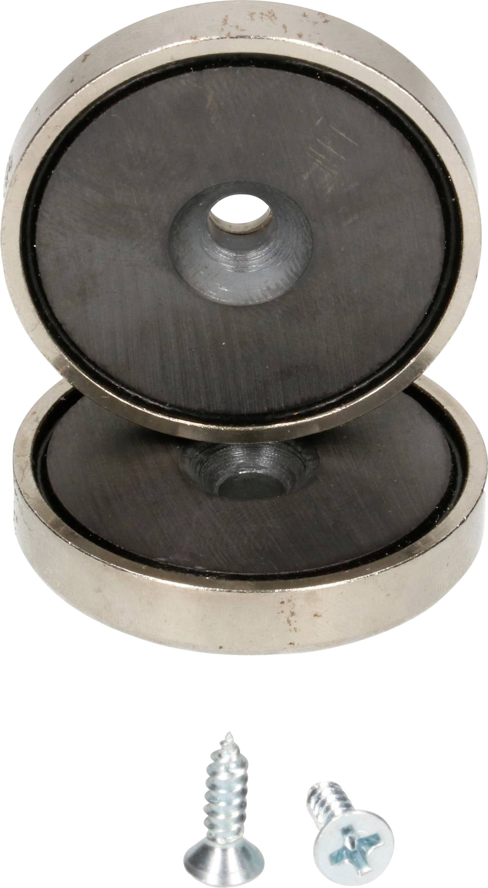 'Zwei runde Magnete mit zentralem Loch, übereinander gestapelt. Zwei Schrauben liegen darunter.'