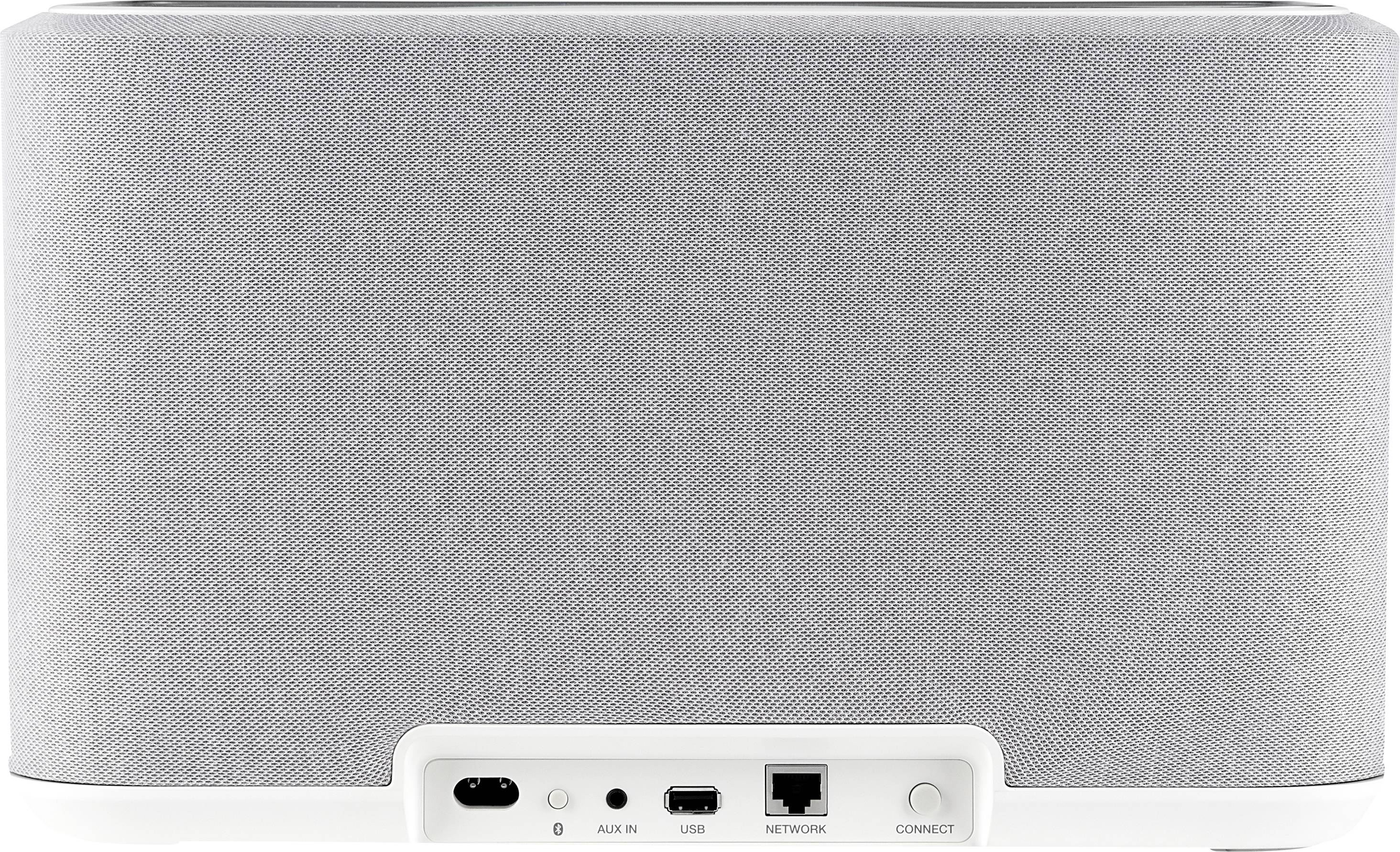 Grauer, rechteckiger Lautsprecher mit weißen Kanten und verschiedenen Anschlüssen auf der Rückseite, darunter USB und Netzwerkanschluss.