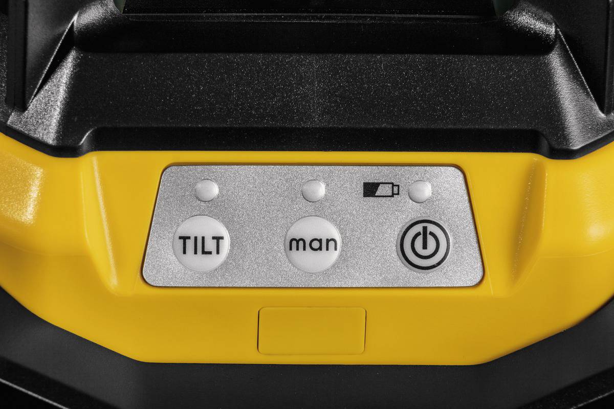 Gelbes und schwarzes Gerät mit drei Knöpfen: 'TILT', 'man', und ein Ein-/Ausschalt-Symbol. Batteriestandanzeige daneben.