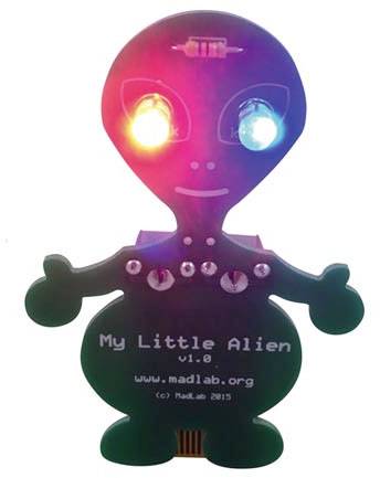 Ein kleiner Roboter in Form eines Aliens mit leuchtenden Augen, eines rot, das andere blau. Text 'My Little Alien v1.0' auf dem Körper.