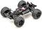 Ein ferngesteuertes Auto-Chassis mit großen, robusten Reifen und sichtbaren Motor- und Federungskomponenten auf heller Oberfläche.