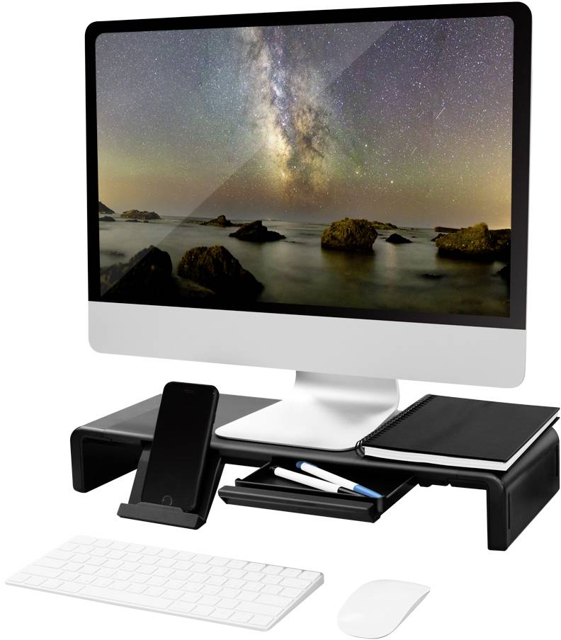 Ein moderner Desktop-Computer auf einem Schreibtisch mit einem Bildschirm, der einen sternenklaren Himmel über einer Küstenlandschaft zeigt. Vor dem Monitor sind eine Tastatur, eine Maus, ein Notizbuch und ein Smartphone platziert.