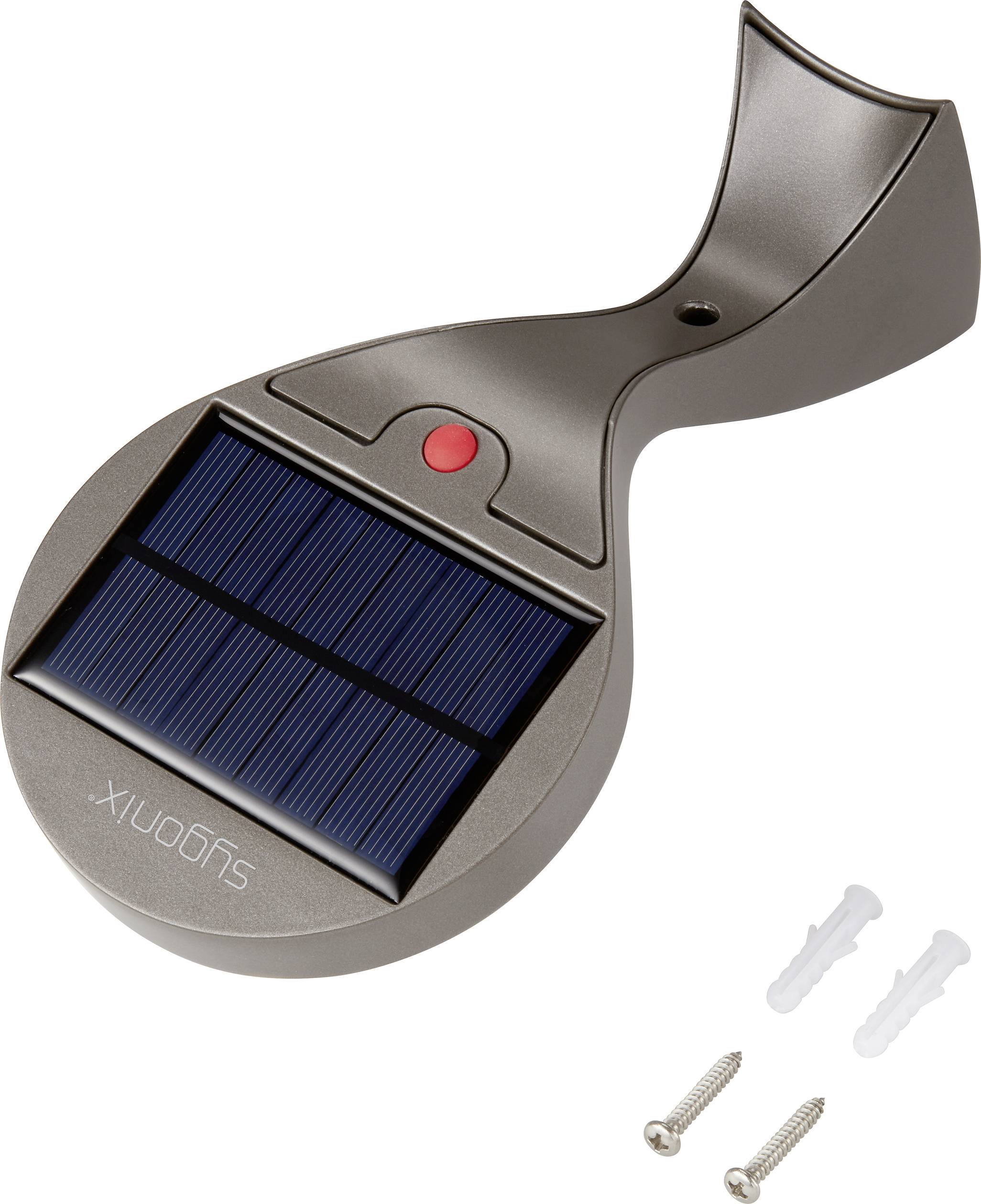 Solarlampe mit dunkelgrauem Gehäuse und Solarpanel oben. Enthält einen roten Knopf. Zwei Schrauben und Dübel liegen daneben.