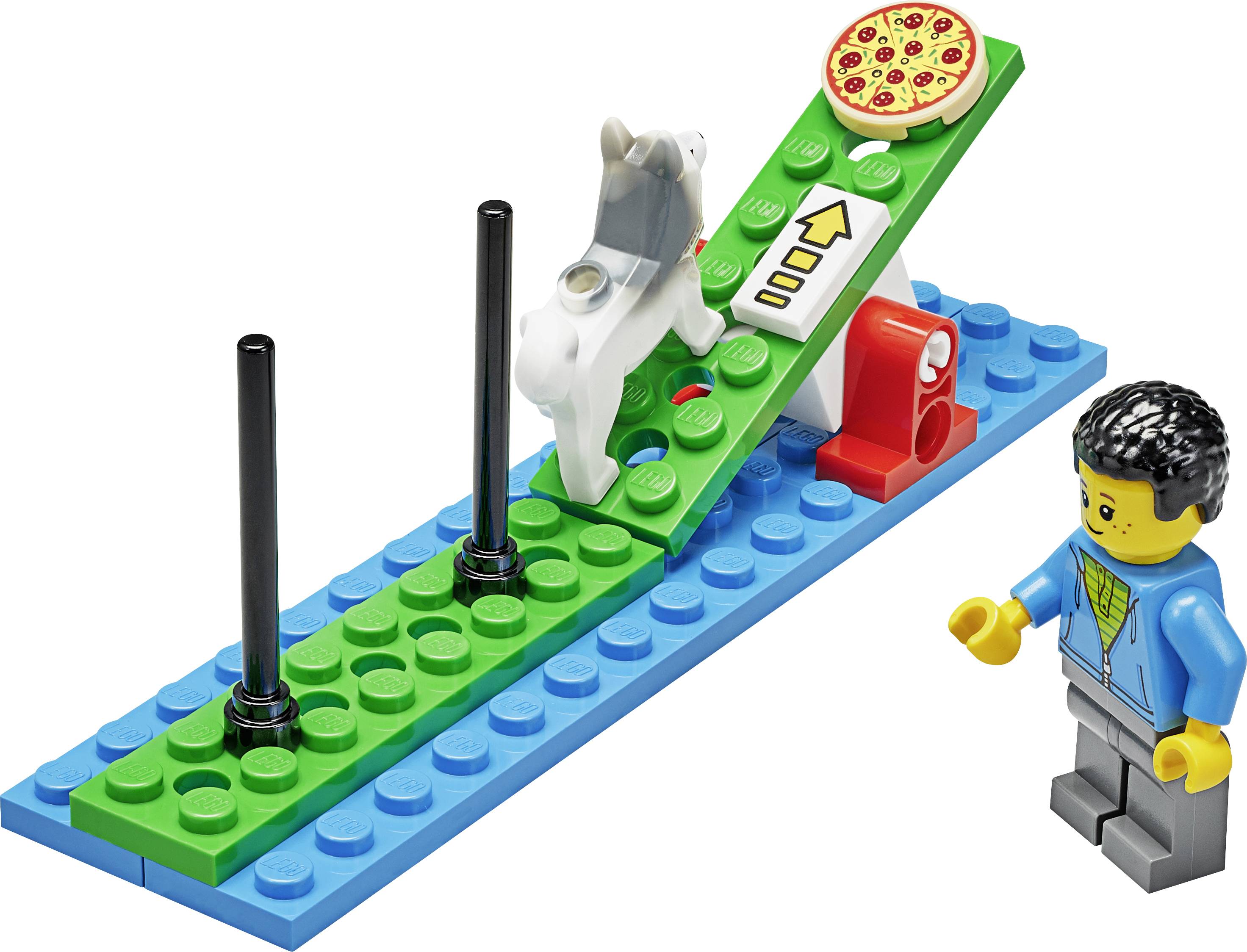 Ein Lego-Set zeigt eine Hundetraining-Szene mit einem Hund auf einer Wippe, einer Pizzascheibe als Anreiz und einer Figur, die zuschaut.