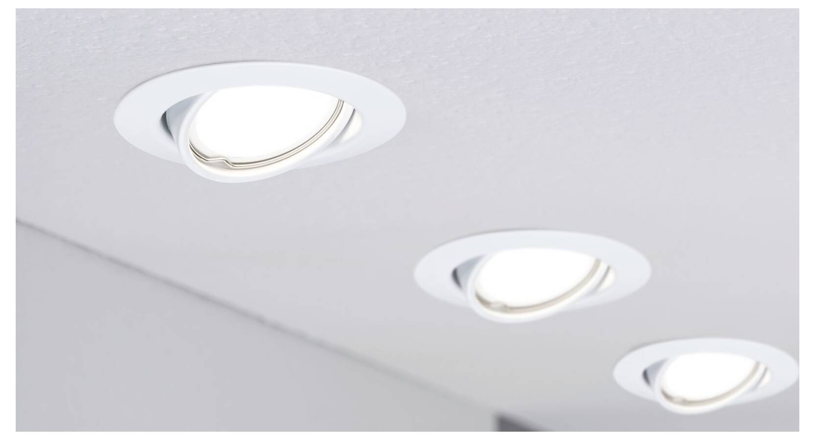 Drei weiße, runde Einbauleuchten in einer Decke, gleichmäßig verteilt, leuchten hell. Modernes und schlichtes Design.