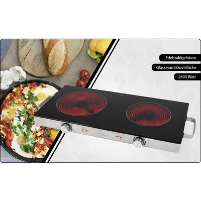 Zwei Glaskeramikkochplatten mit Edelstahlgehäuse, 2800 Watt. Im Hintergrund ein Frühstück mit Brot, Käse, Paprika und einem gebratenen Ei-Gericht.