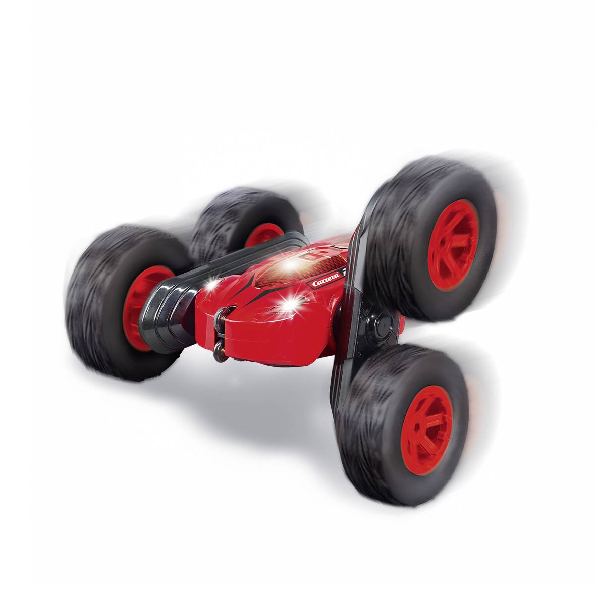 Ein rotes ferngesteuertes Auto mit großen schwarzen Reifen, das sich schnell bewegt und seitwärts kippt.