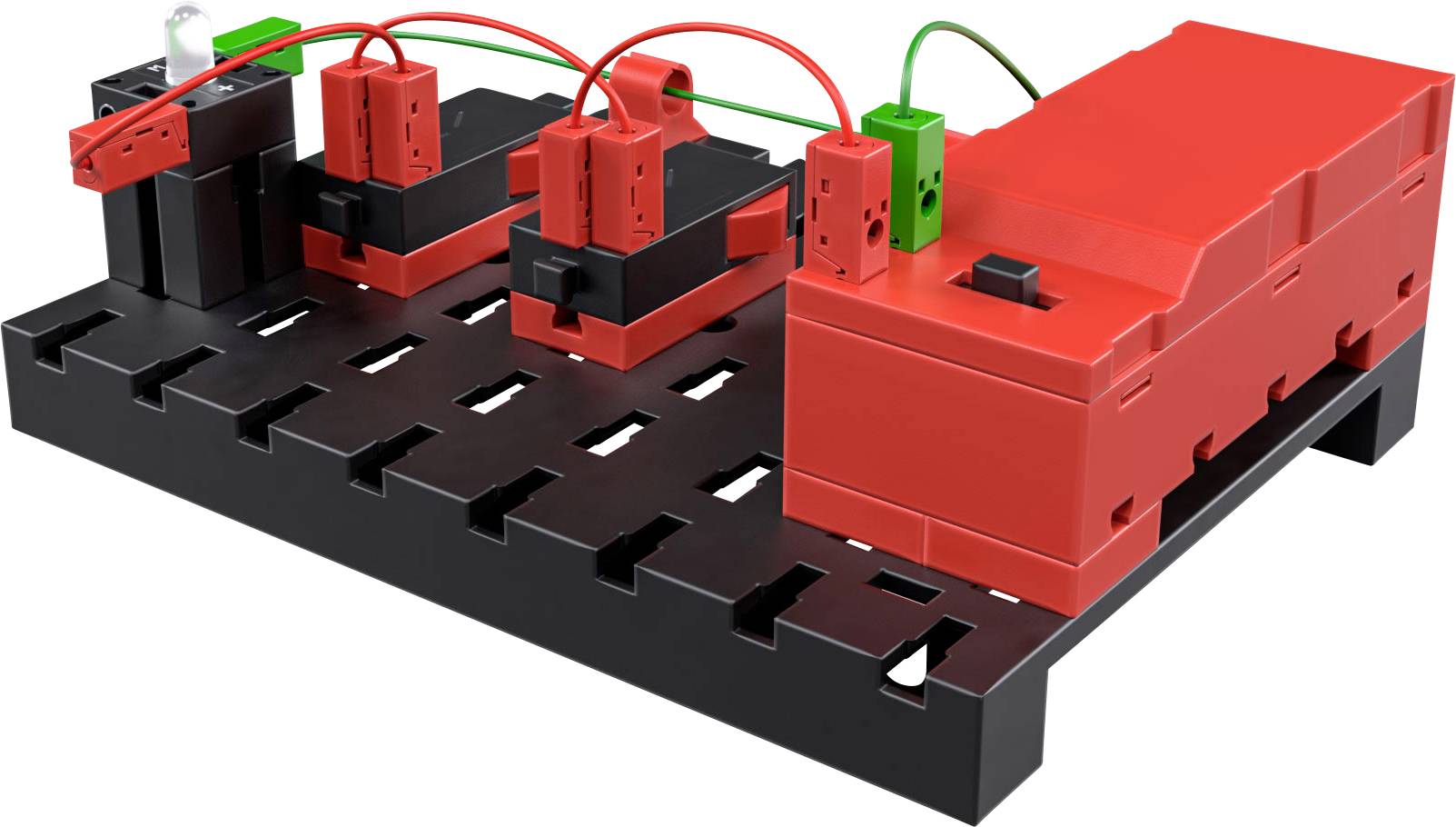 Elektronisches Lernkit mit rotem und schwarzem Bauteil auf schwarzer Basis. Verschiedene Module sind verdrahtet und miteinander verbunden.