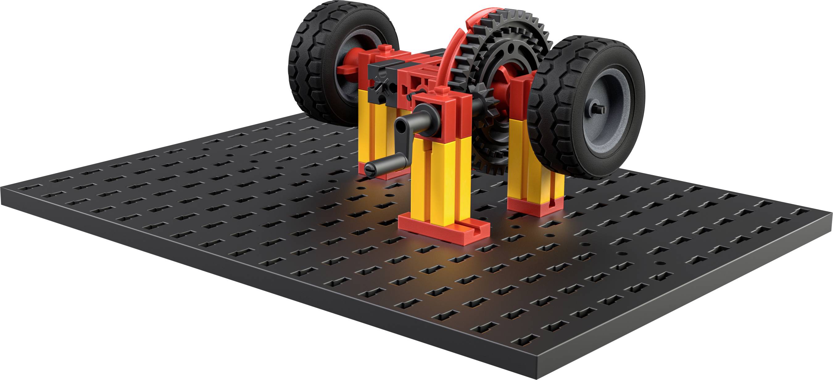 Ein Modell aus Bausteinen, das ein Getriebe mit zwei Rädern auf einer schwarzen Platte zeigt, eventuell zur Demonstration mechanischer Vorgänge.