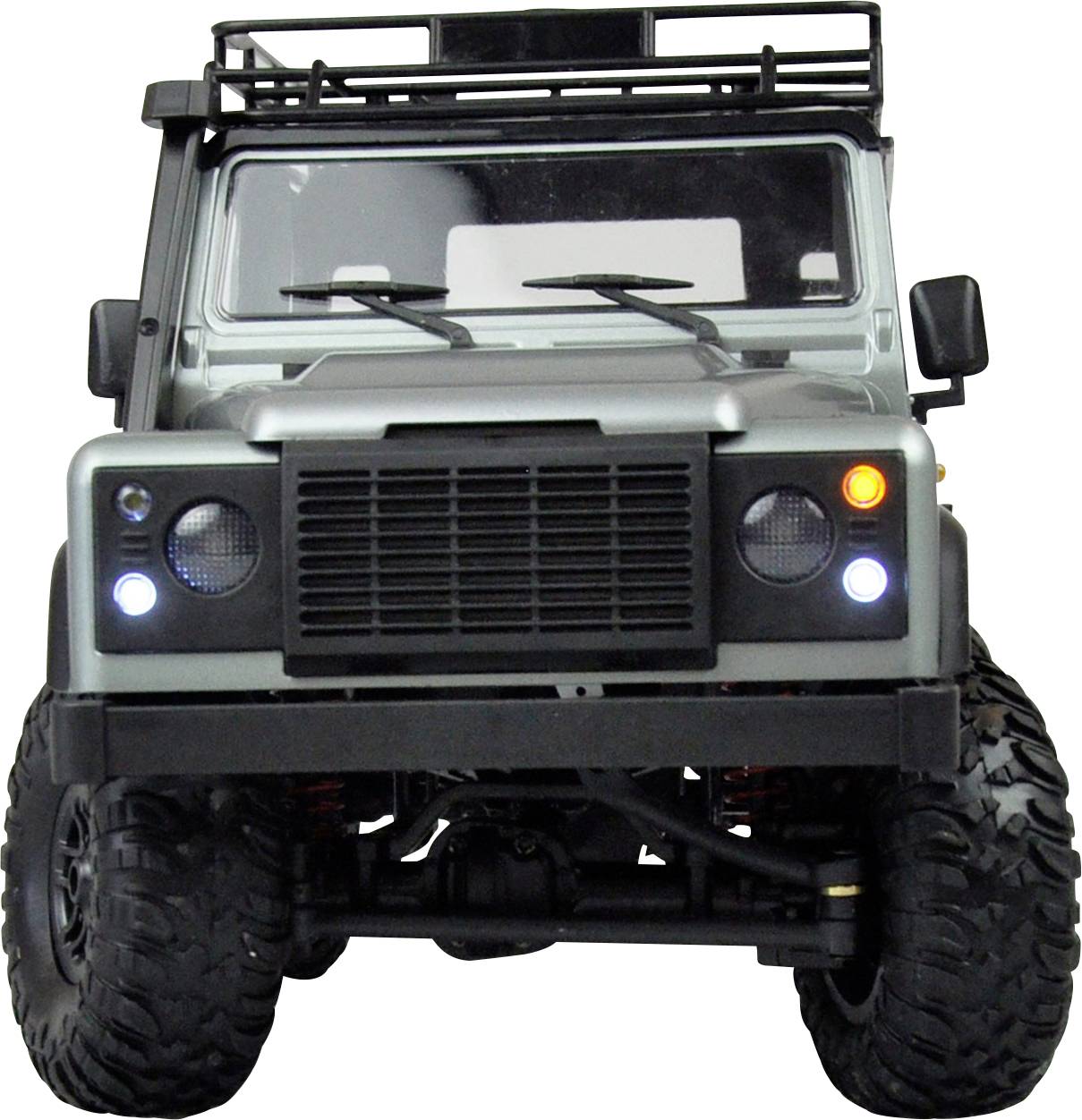 Geländewagen in Frontalansicht, robustes Design mit großen Reifen. Hauptscheinwerfer sind eingeschaltet. 