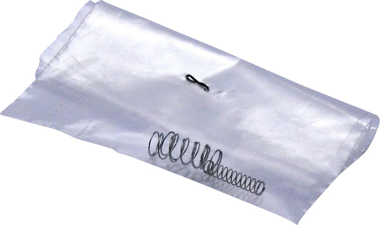 Kleine Metallfeder in einer transparenten Plastiktüte.