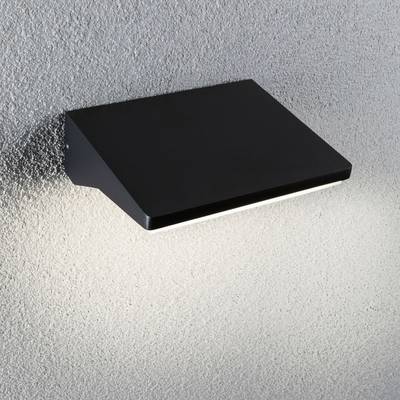Eine schwarze, rechteckige Wandleuchte auf einer grauen Oberfläche leuchtet nach unten und erzeugt einen Lichtschein.