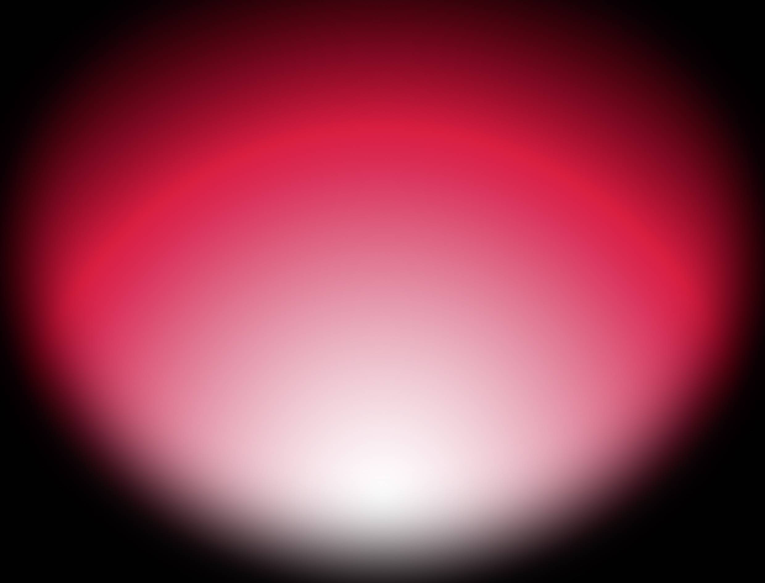 Ein heller rot-weiß verlaufender Lichtschein, der in der Mitte intensiviert ist und nach außen dunkel wird, auf schwarzem Hintergrund.
