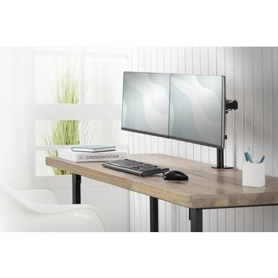 Ein Schreibtisch mit einem Doppelmonitor-Setup, daneben eine Tastatur und Maus. Ein Buch mit dem Titel 'Communication' liegt links.