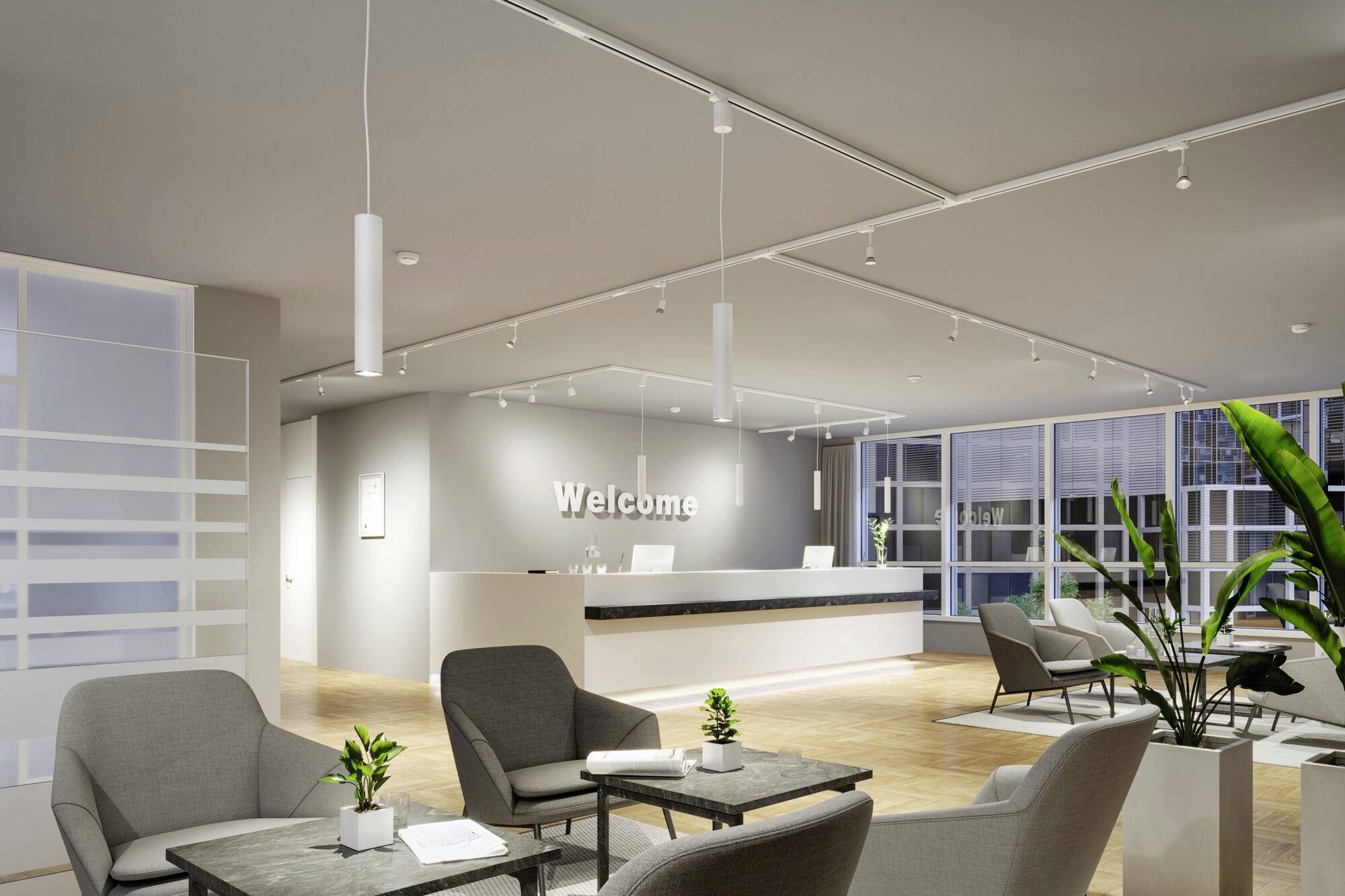 Empfangsbereich eines modernen Büros mit hellen Möbeln, Pflanzen und der Aufschrift 'Welcome' an der Wand.