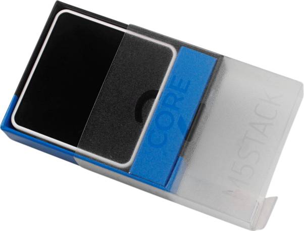 Eine kleine, rechteckige elektronische Komponente mit einem Display in einer durchsichtigen Kunststoffverpackung, beschriftet mit 'M5STACK'.