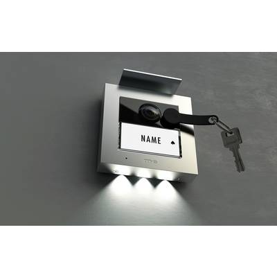 Schlüsselschalter an einer Wand mit zwei leuchtenden LEDs. Ein Schlüssel hängt im Schloss, und darunter steht 'NAME'.