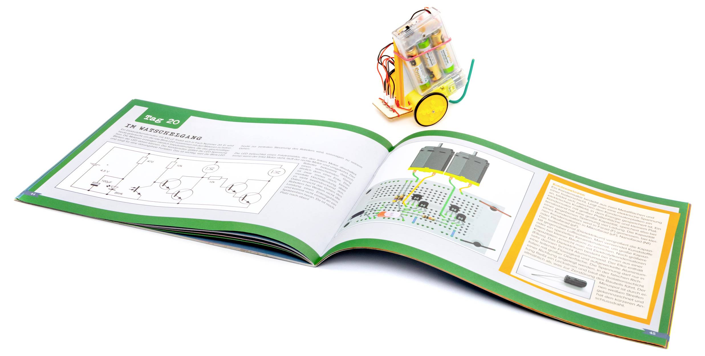Ein offenes Naturwissenschaftslehrbuch mit Schaltschemen neben einem kleinen Roboter-Set mit Rädern, das Robotik- und Elektronik-Lernmöglichkeiten veranschaulicht.