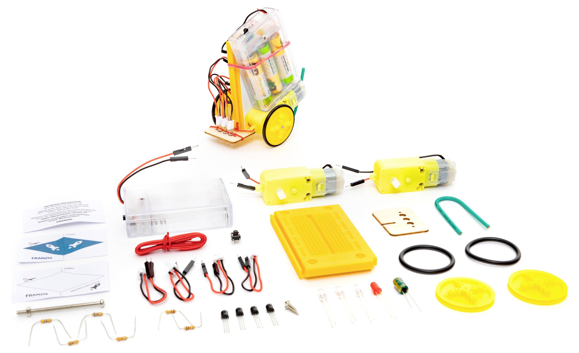 Ein Wissenschaftsset mit einem rollbaren Batteriefach, Drähten, Motoren, Schaltern, LEDs, Widerständen und Kunststoff-Experimentierteilen auf weißem Hintergrund.