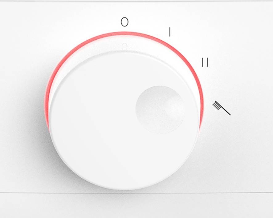 Ein weißer Drehknopf mit roten Akzenten zeigt Positionen '0', 'I', 'II' und ein Pinsel-Symbol, vermutlich zur Steuerung eines Geräts.