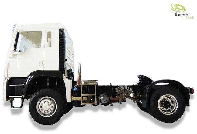 Ein weißer Lastwagen ohne Ladefläche, seitliche Ansicht, zeigt das Fahrgestell und die hinteren Räder. Oben rechts ist ein Logo.
