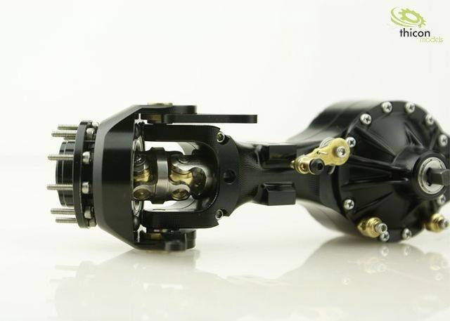 'Schwarze, metallische Modell-Komponente mit goldenen Details, zeigt komplexe mechanische Teile und eine Verbindungseinheit, seitlich fotografiert.'