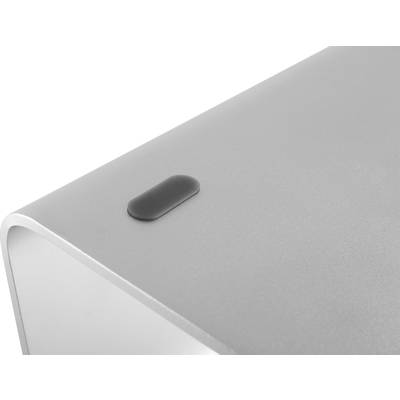 Graue, gebogene Ecke eines modernen elektronischen Geräts mit schwarzem, rechteckigem Gummifuß auf einer hellen Oberfläche.