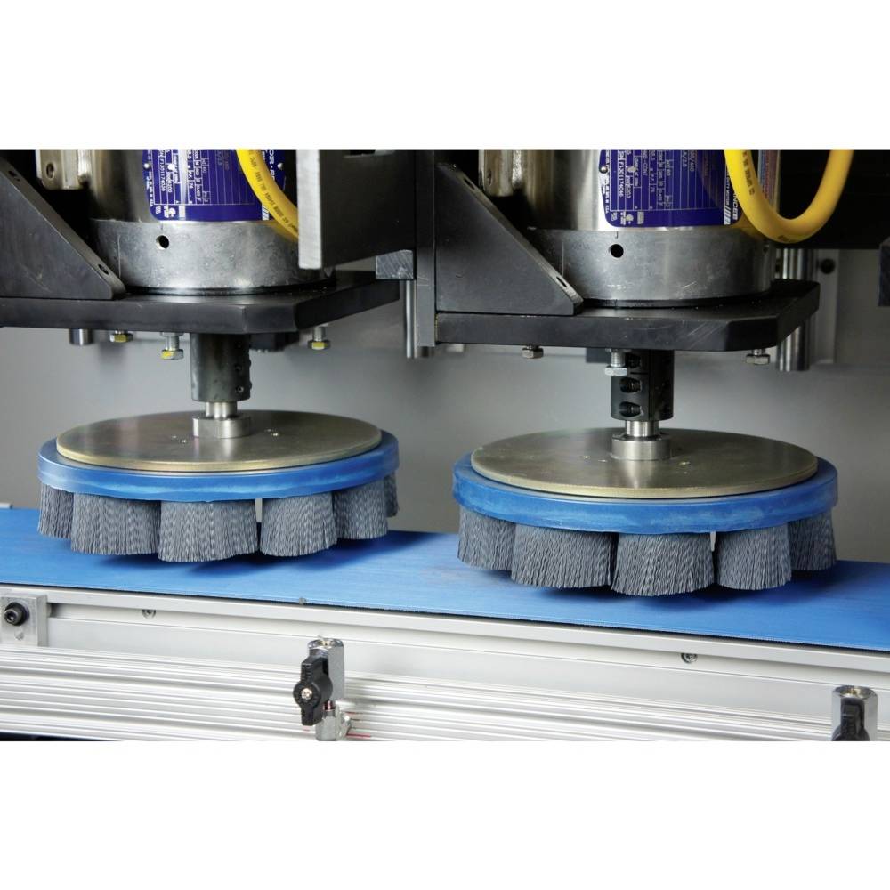 Maschine zum Polieren von Oberflächen mit zwei rotierenden Bürsten auf einem blauen Förderband, in einer industriellen Umgebung.