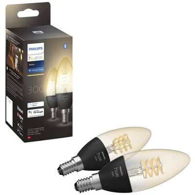 Zwei Philips Hue Filament Kerzenlampen vor der Verpackung dargestellt. Lampen zeigen spiralförmige Glühdraht-Optik, passend für E14-Fassung.