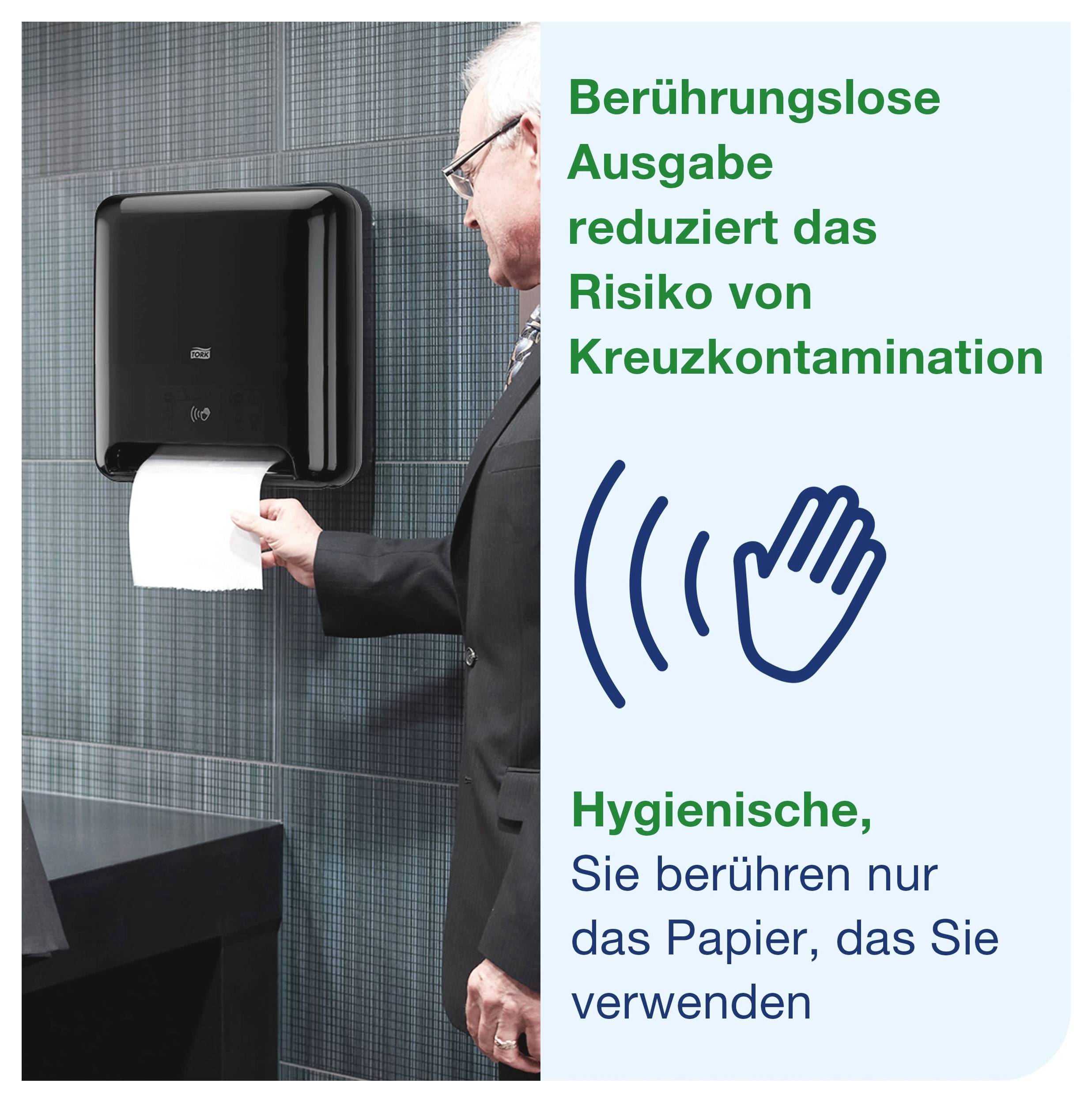Mann entnimmt Papier aus berührungslosem Spender; Hinweistext: 'Berührungslose Ausgabe reduziert das Risiko von Kreuzkontamination' und 'Hygienische, Sie berühren nur das Papier, das Sie verwenden'.