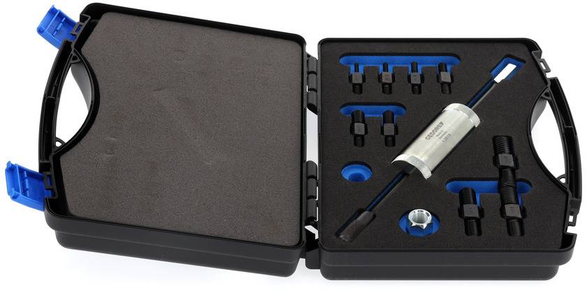 Ein geöffneter schwarzer Werkzeugkoffer mit verschiedenen kleinen Werkzeugen und einem zylindrischen Gerät im Inneren.