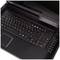 Ein schwarzer Laptop mit Tastatur und Touchpad ist geöffnet. Oben sind mehrere runde Tasten sichtbar. Der Bildschirm ist unklar.