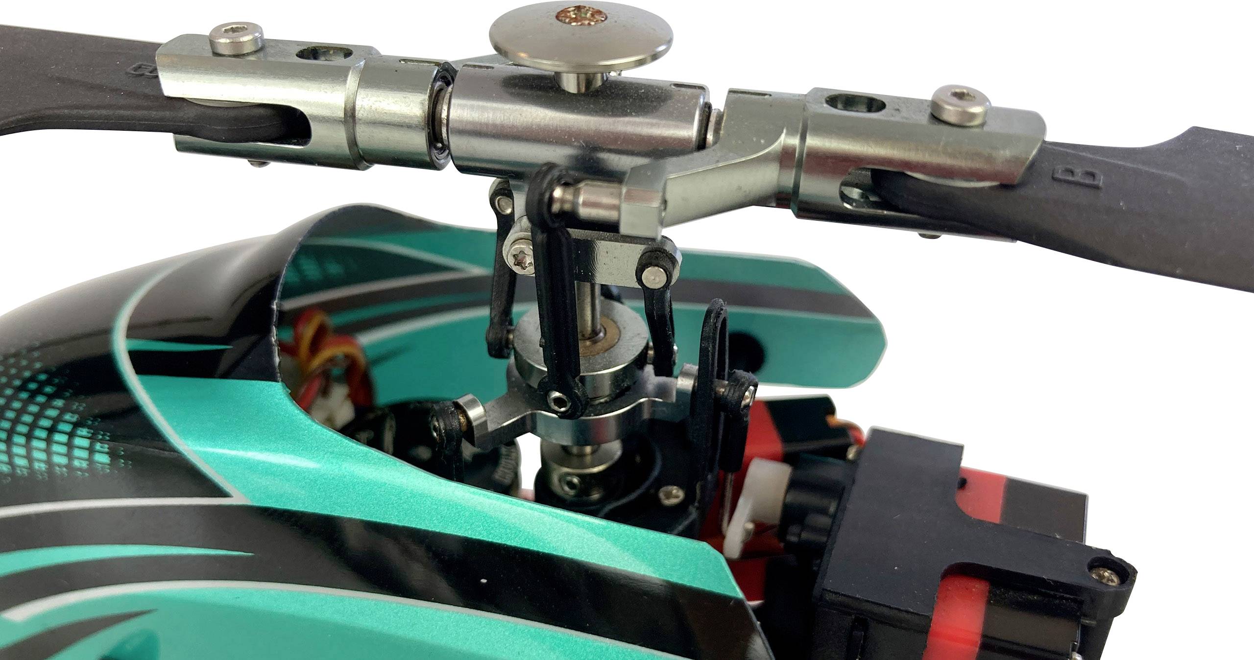 Nahaufnahme eines Modellhubschrauber-Rotorkopfes mit grüner und schwarzer Verkleidung, zeigt die Mechanik und Details der Rotorblätter.