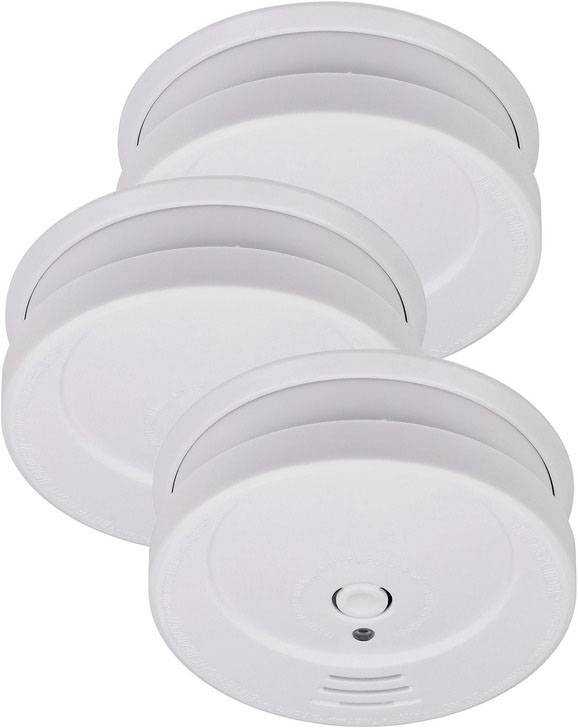 Drei weiße Rauchmelder in einer leicht versetzten Anordnung, jeweils mit rundem Gehäuse und zentralem Testknopf.
