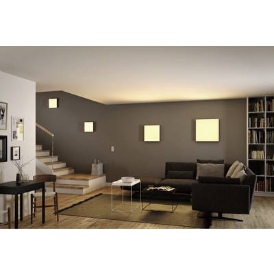 Gemütliches Wohnzimmer mit dunklem Sofa, schwarzem Tisch, Treibholz-Parkettboden, moderner Wandbeleuchtung und Regalwand.