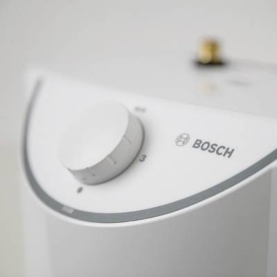 Nahaufnahme eines Bosch-Wassererhitzers mit einem Drehknopf zur Temperatureinstellung, gezeigt in einer neutralen Umgebung.