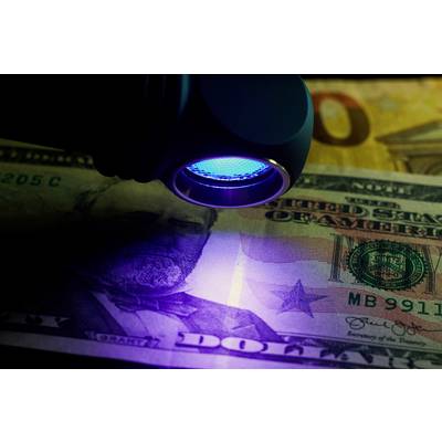 Eine Banknote unter UV-Licht zeigt Sicherheitsmerkmale zur Überprüfung der Echtheit.