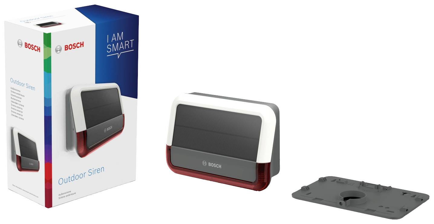 Eine Outdoor-Sirene von Bosch neben ihrer Verpackung und einer Montageplatte. Die Verpackung trägt den Schriftzug 'I AM SMART'.
